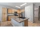 Kitchen featuring light wood cabinets, stainless steel appliances, and a large island with a sink at 396 S 166Th Dr, Goodyear, AZ 85338