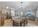 Open-concept kitchen with a breakfast bar, seamlessly connecting the living area and dining space at 396 S 166Th Dr, Goodyear, AZ 85338