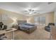 Bedroom featuring a large window, ceiling fan, and neutral carpeting at 396 S 166Th Dr, Goodyear, AZ 85338