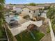 Inviting backyard features a pool, outdoor kitchen, playground, and lush landscaping at 40161 N Westray Way, San Tan Valley, AZ 85140