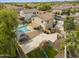 Aerial view of lush backyard with pool, spa, outdoor kitchen, and playground area at 40161 N Westray Way, San Tan Valley, AZ 85140
