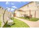 Serene backyard featuring a patio with a dining table, with a grassy area for relaxation and outdoor activities at 40161 N Westray Way, San Tan Valley, AZ 85140