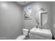 A clean, contemporary half bathroom with a round mirror and modern fixtures at 40161 N Westray Way, San Tan Valley, AZ 85140
