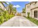 Long driveway leading to a gated backyard, lined with desert landscaping and privacy at 40161 N Westray Way, San Tan Valley, AZ 85140