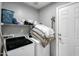 Functional laundry room with shelving, modern washer and dryer, plus convenient access to the door at 40161 N Westray Way, San Tan Valley, AZ 85140