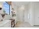 Bright bathroom featuring dual sinks, a large window, and a glass-enclosed shower at 42046 N Golden Trl, San Tan Valley, AZ 85140