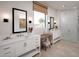 Bright bathroom featuring dual sinks, a large window, and a glass-enclosed shower at 42046 N Golden Trl, San Tan Valley, AZ 85140