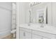 Elegant bathroom featuring double sinks, white cabinetry, and a shower with glass doors at 42046 N Golden Trl, San Tan Valley, AZ 85140