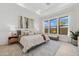 Serene bedroom featuring large windows, a plush bed, and a stylish rug at 42046 N Golden Trl, San Tan Valley, AZ 85140