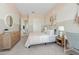 Calm bedroom with neutral tones, a stylish dresser, and a well-lit workspace at 42046 N Golden Trl, San Tan Valley, AZ 85140