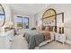 Stylish bedroom featuring modern art, a comfy bed, and bright natural light at 42046 N Golden Trl, San Tan Valley, AZ 85140