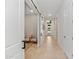 Long hallway with tile floors, white walls, and a sliding barn door for added style and privacy at 42046 N Golden Trl, San Tan Valley, AZ 85140
