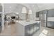 Open kitchen featuring a large island with seating, gray cabinets, and stainless steel refrigerator at 42046 N Golden Trl, San Tan Valley, AZ 85140
