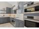 Modern kitchen showing the built-in stainless steel ovens and range with gray cabinets at 42046 N Golden Trl, San Tan Valley, AZ 85140