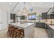 Contemporary kitchen featuring an island with seating, stylish pendant lighting, and gray cabinetry at 42046 N Golden Trl, San Tan Valley, AZ 85140