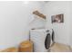 Clean laundry room with modern washer and dryer, plus storage shelves and decorative elements at 42046 N Golden Trl, San Tan Valley, AZ 85140