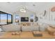 Stylish living room with a comfortable sectional sofa, modern decor, and plenty of natural light from large windows at 42046 N Golden Trl, San Tan Valley, AZ 85140