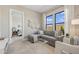 Stylish living room with a comfortable sectional sofa and adjacent bedroom offers a cozy retreat at 42046 N Golden Trl, San Tan Valley, AZ 85140