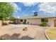 A spacious backyard features a fire pit, covered patio, and low-maintenance desert landscaping at 4842 W Christine Cir, Glendale, AZ 85308
