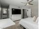 Bedroom with gray walls featuring a large flat screen television and access to the ensuite bathroom at 4842 W Christine Cir, Glendale, AZ 85308