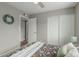 Bedroom featuring a floral-patterned bed, neutral-toned walls, and a closet with sliding doors at 4842 W Christine Cir, Glendale, AZ 85308