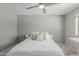 Bright bedroom with neutral walls, a ceiling fan, and a view of the outside neighborhood at 4842 W Christine Cir, Glendale, AZ 85308