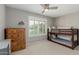 Cozy bedroom featuring a wooden bunk bed, soft carpet, and a window with bright light at 4842 W Christine Cir, Glendale, AZ 85308