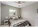 Comfortable bedroom with a floral-patterned bed, soft bedding, and natural light from a window at 4842 W Christine Cir, Glendale, AZ 85308