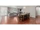 Open-concept dining area featuring a modern light fixture, stylish table set, and seamless transition to the living room at 4842 W Christine Cir, Glendale, AZ 85308