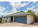 Charming single-story home showing an attached two-car garage with blue trim at 4842 W Christine Cir, Glendale, AZ 85308