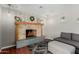Charming fireplace with mantel decorated with stylish decor, and comfortable seating at 4842 W Christine Cir, Glendale, AZ 85308