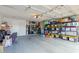 Functional garage featuring ample storage shelves, tools, and neatly organized storage bins at 4842 W Christine Cir, Glendale, AZ 85308
