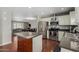 Well-equipped kitchen featuring stainless steel appliances, custom cabinets, and granite countertops, with an island at 4842 W Christine Cir, Glendale, AZ 85308