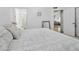 Comfortable bedroom featuring soft bedding, a mirror, and views into the bathroom and hallway at 542 S Higley Rd # 52, Mesa, AZ 85206