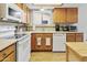 Efficient kitchen features white appliances, wood cabinets and sleek countertops at 542 S Higley Rd # 52, Mesa, AZ 85206