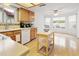 Bright kitchen featuring wood cabinets, white appliances, and a breakfast nook area at 542 S Higley Rd # 52, Mesa, AZ 85206