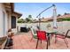 Private patio with a tiled surface, colorful chairs, and shaded seating area, perfect for entertaining at 542 S Higley Rd # 52, Mesa, AZ 85206