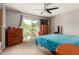 Bedroom with sliding door access to the backyard, ceiling fan, and neutral carpet at 5537 W Boca Raton Rd, Glendale, AZ 85306