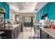 Bright kitchen featuring white tile floors, stainless steel appliances, and blue cabinets at 5537 W Boca Raton Rd, Glendale, AZ 85306