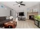 Comfortable living room featuring a cozy sofa and a classic brick fireplace at 5537 W Boca Raton Rd, Glendale, AZ 85306