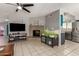 Spacious living room with fireplace and view into the kitchen with stainless fridge at 5537 W Boca Raton Rd, Glendale, AZ 85306