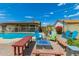 Outdoor living with a swimming pool, firepit with chairs, and paver patio at 5537 W Boca Raton Rd, Glendale, AZ 85306