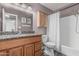 The well-lit bathroom is equipped with a granite countertop vanity, a modern toilet, and a bathtub with shower at 5877 N Granite Reef Rd # 2240, Scottsdale, AZ 85250