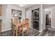 Charming dining area featuring a wooden table, four chairs, and a stacked washer and dryer hidden behind closet doors at 5877 N Granite Reef Rd # 2240, Scottsdale, AZ 85250
