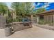 Community grill with concrete base, metal door and grill on concrete patio at 5877 N Granite Reef Rd # 2240, Scottsdale, AZ 85250