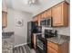 Efficient kitchen featuring black appliances, granite countertops, and ample cabinet space at 5877 N Granite Reef Rd # 2240, Scottsdale, AZ 85250
