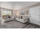 Comfortable living room featuring a gray sofa set, carpeted floors, and access to an outdoor balcony at 5877 N Granite Reef Rd # 2240, Scottsdale, AZ 85250
