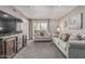 Inviting living room with gray sofa set, balcony access, and a spacious layout at 5877 N Granite Reef Rd # 2240, Scottsdale, AZ 85250