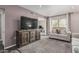 Open-concept living room with a large TV, comfortable seating, and balcony access at 5877 N Granite Reef Rd # 2240, Scottsdale, AZ 85250