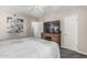 Spacious main bedroom showcasing a large TV on a wooden dresser, offering a perfect blend of relaxation and entertainment at 5877 N Granite Reef Rd # 2240, Scottsdale, AZ 85250